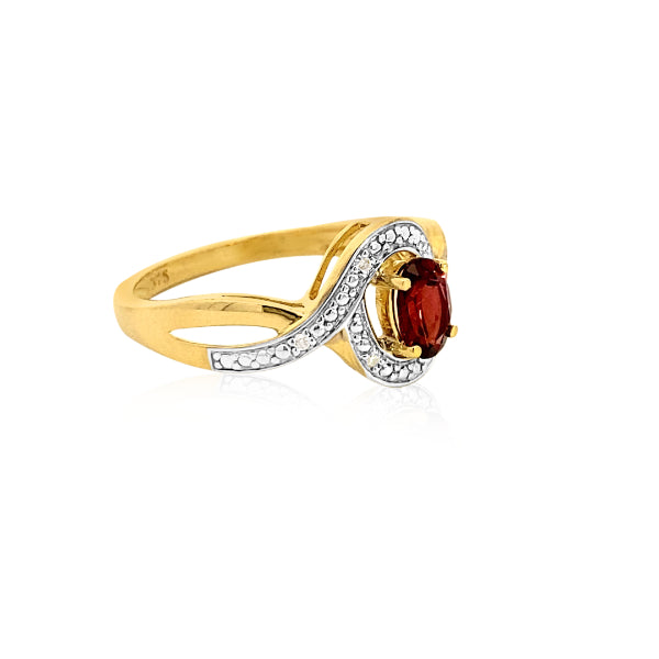 Oval garnet dress ring in a curved diamond halo in 9ct yellow gold