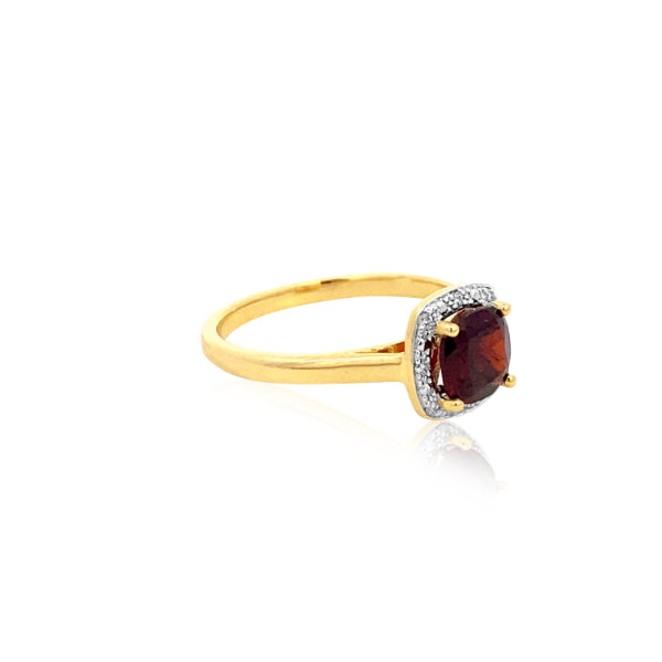 Cushion cut garnet dress ring with diamond halo in 9ct yellow gold