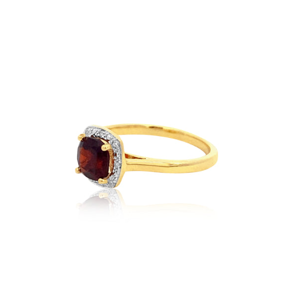 Cushion cut garnet dress ring with diamond halo in 9ct yellow gold