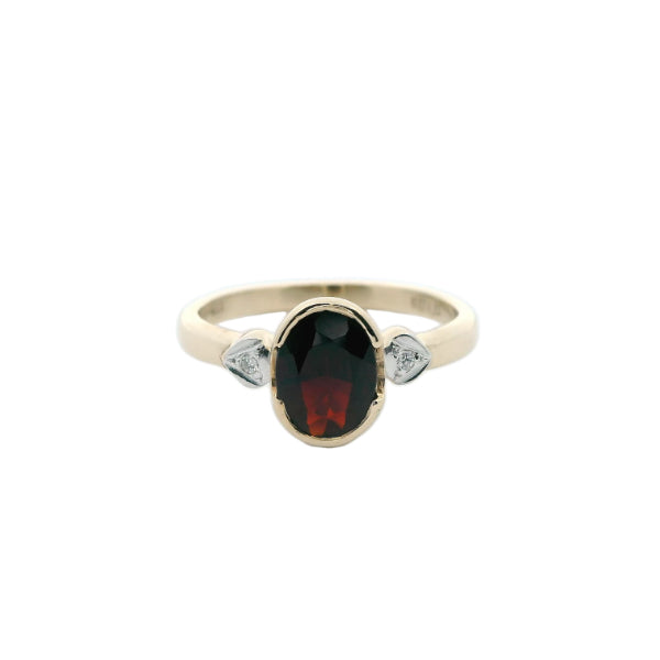 Garnet dress ring with diamond set shoulders in 9ct yellow gold