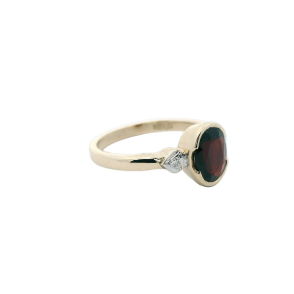 Garnet dress ring with diamond set shoulders in 9ct yellow gold