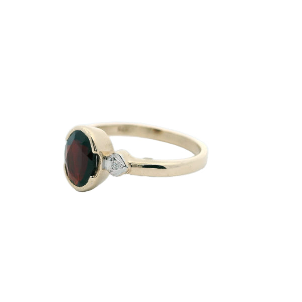Garnet dress ring with diamond set shoulders in 9ct yellow gold