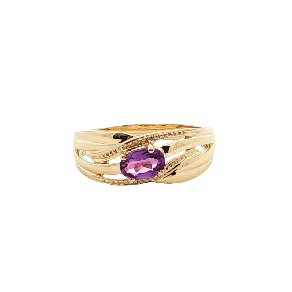 Oval amethyst ring on patterned ribbon band in 9ct yellow gold