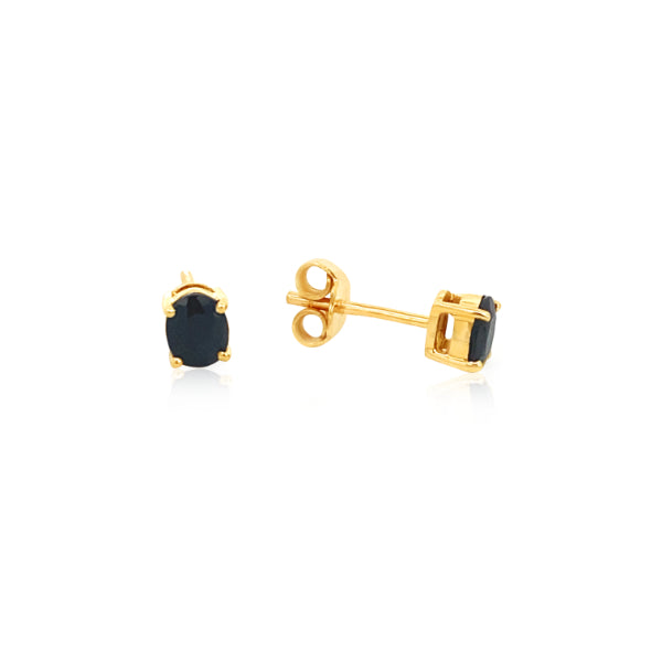 Oval dark blue sapphire stud earrings in 9ct yellow gold