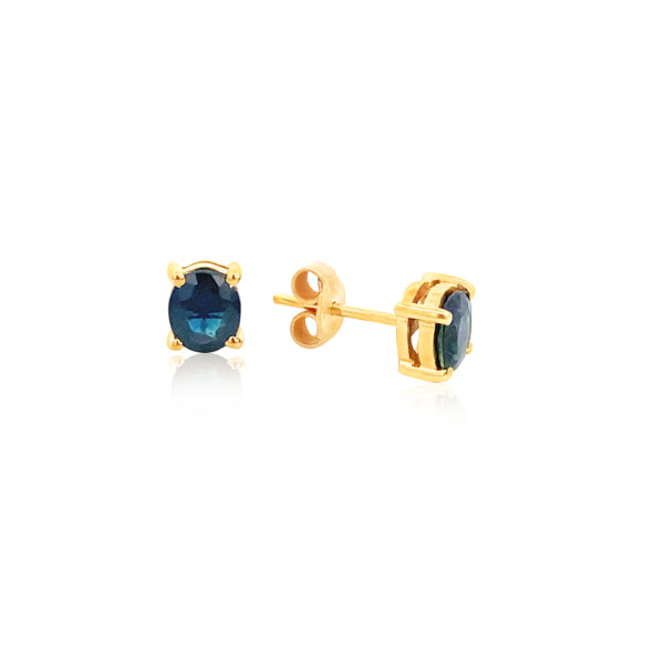 Oval dark blue sapphire stud earrings in 9ct yellow gold