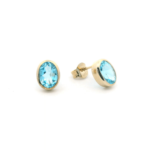 Oval blue topaz rubover stud earrings in 9ct yellow gold