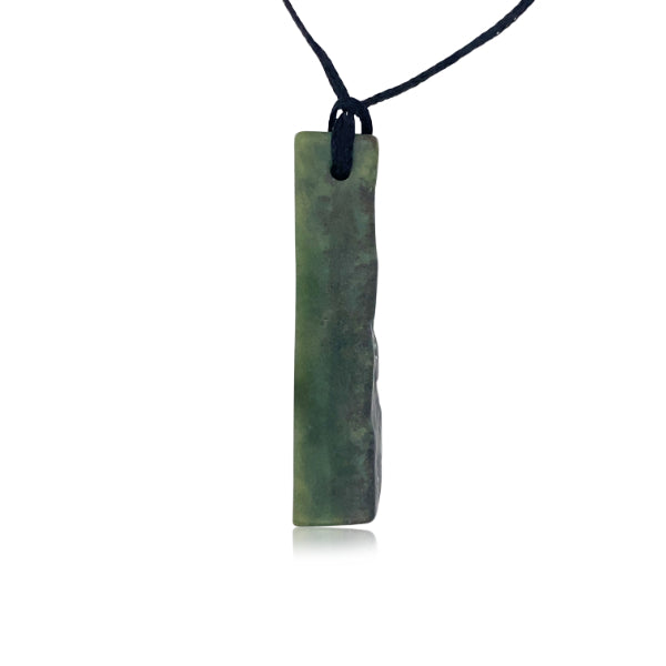 Greenstone free form rectangular drop with natural edge on slider cord