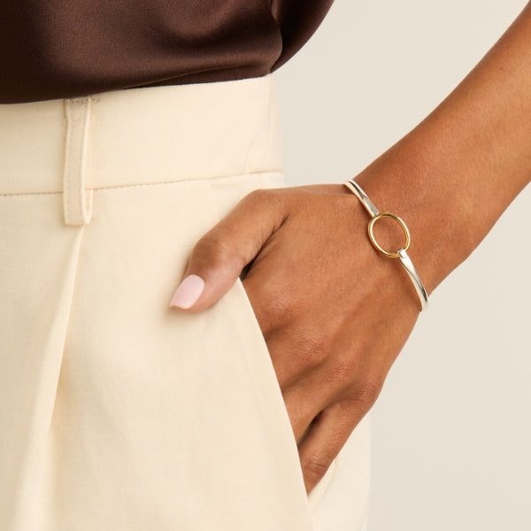 Najo fine bangle in sterling silver with gold tone oval ring clasp
