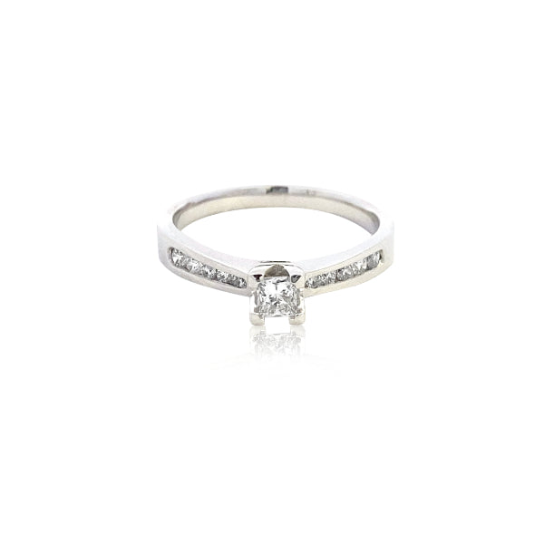 Yoko - 18ct white gold princess cut diamond solitaire engagement ring with diamond channel set shoulder stones