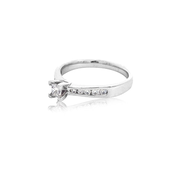Yoko - 18ct white gold princess cut diamond solitaire engagement ring with diamond channel set shoulder stones