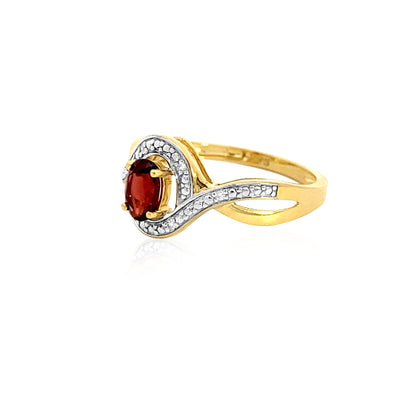 Oval garnet dress ring in a curved diamond halo in 9ct yellow gold