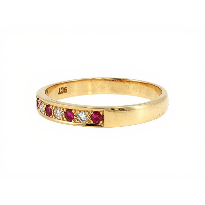 Ruby and three stone diamond bead set ring in 9ct yellow gold