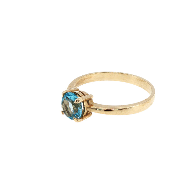 Round blue topaz solitaire dress ring in 9ct yellow gold
