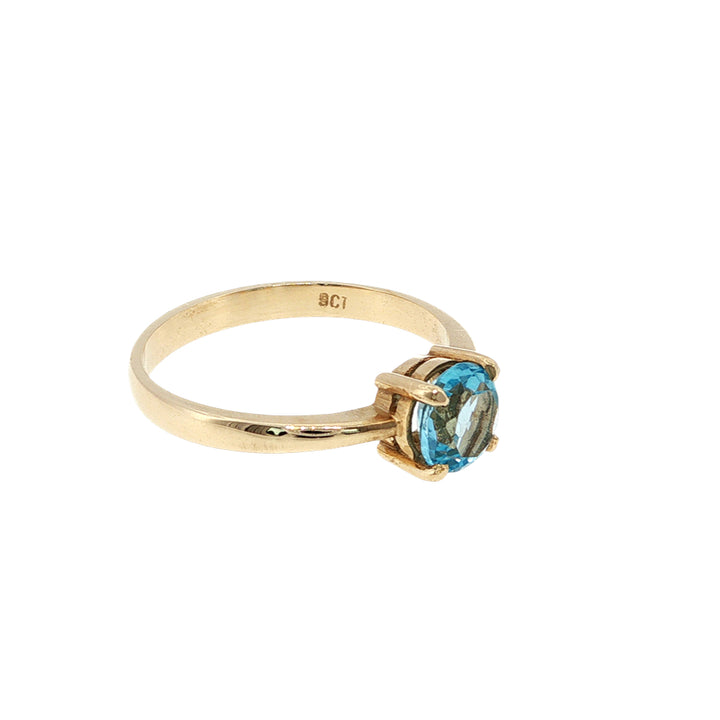Round blue topaz solitaire dress ring in 9ct yellow gold