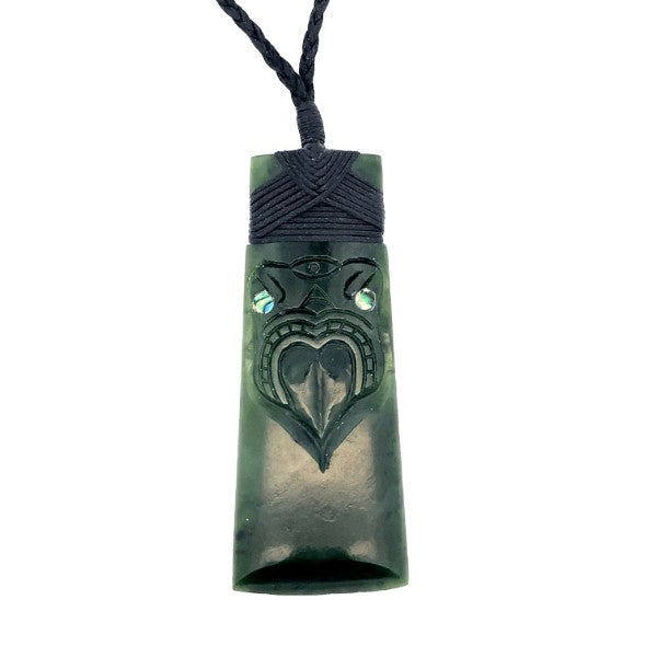 NZ Greenstone pounamu toki pendant with engraved mask and paua set eyes