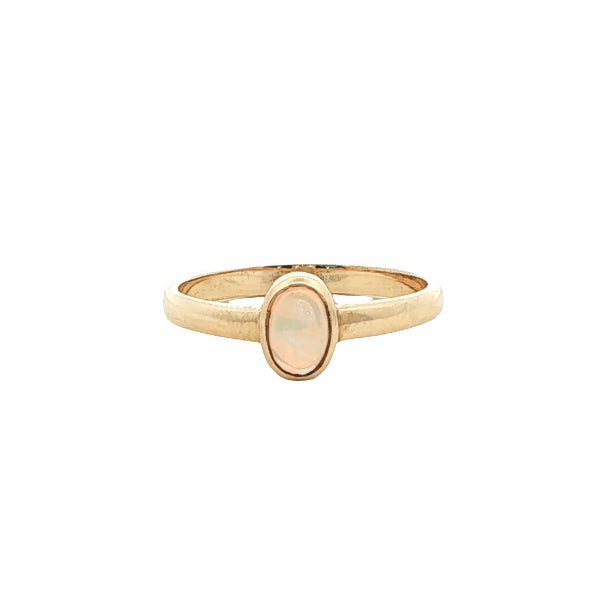 White oval opal rubover ring n 9ct yellow gold