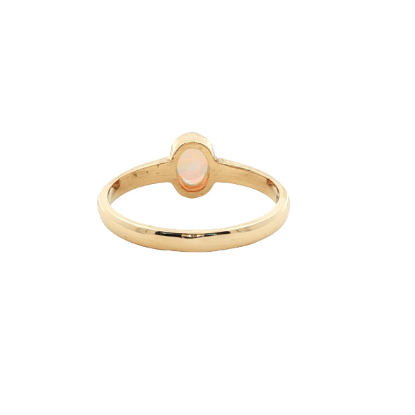 White oval opal rubover ring n 9ct yellow gold