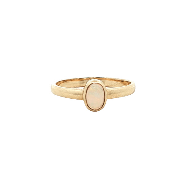 White oval opal rubover ring n 9ct yellow gold