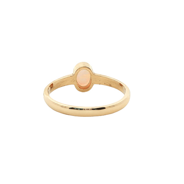 White oval opal rubover ring n 9ct yellow gold