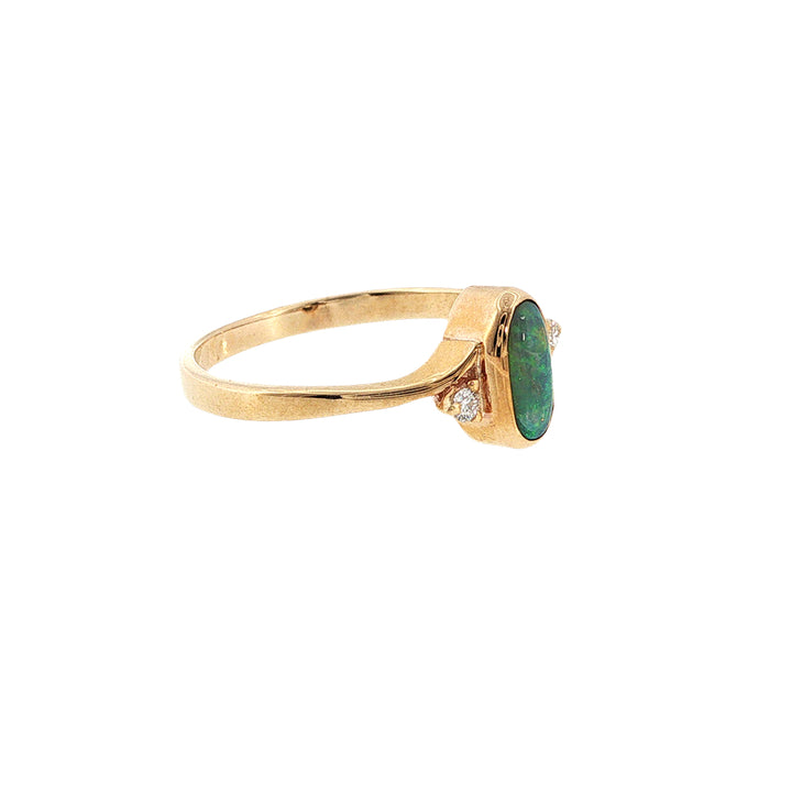 Australian opal rubover set ring with two diamonds in 9ct yellow gold.