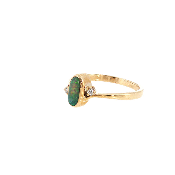 Australian opal rubover set ring with two diamonds in 9ct yellow gold.