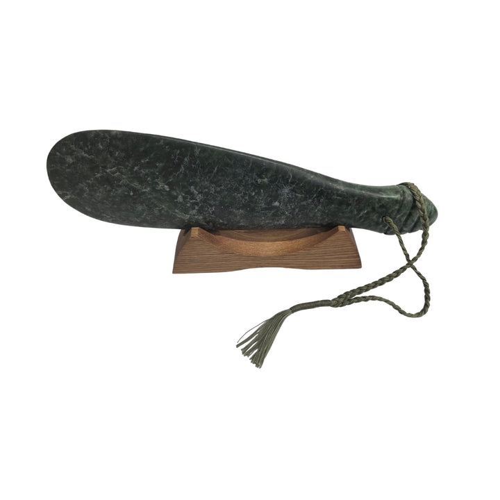 NZ pounamu greenstone mere with green cord and wooden stand