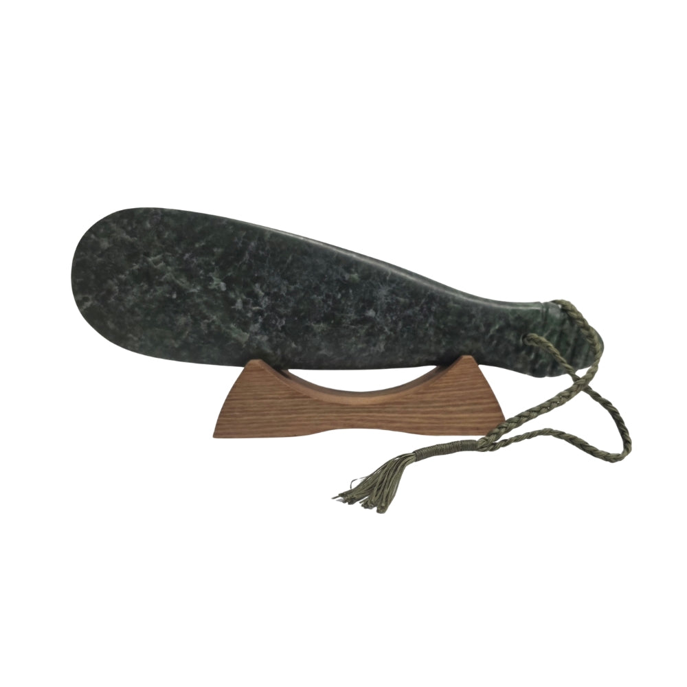 NZ pounamu greenstone mere with green cord and wooden stand