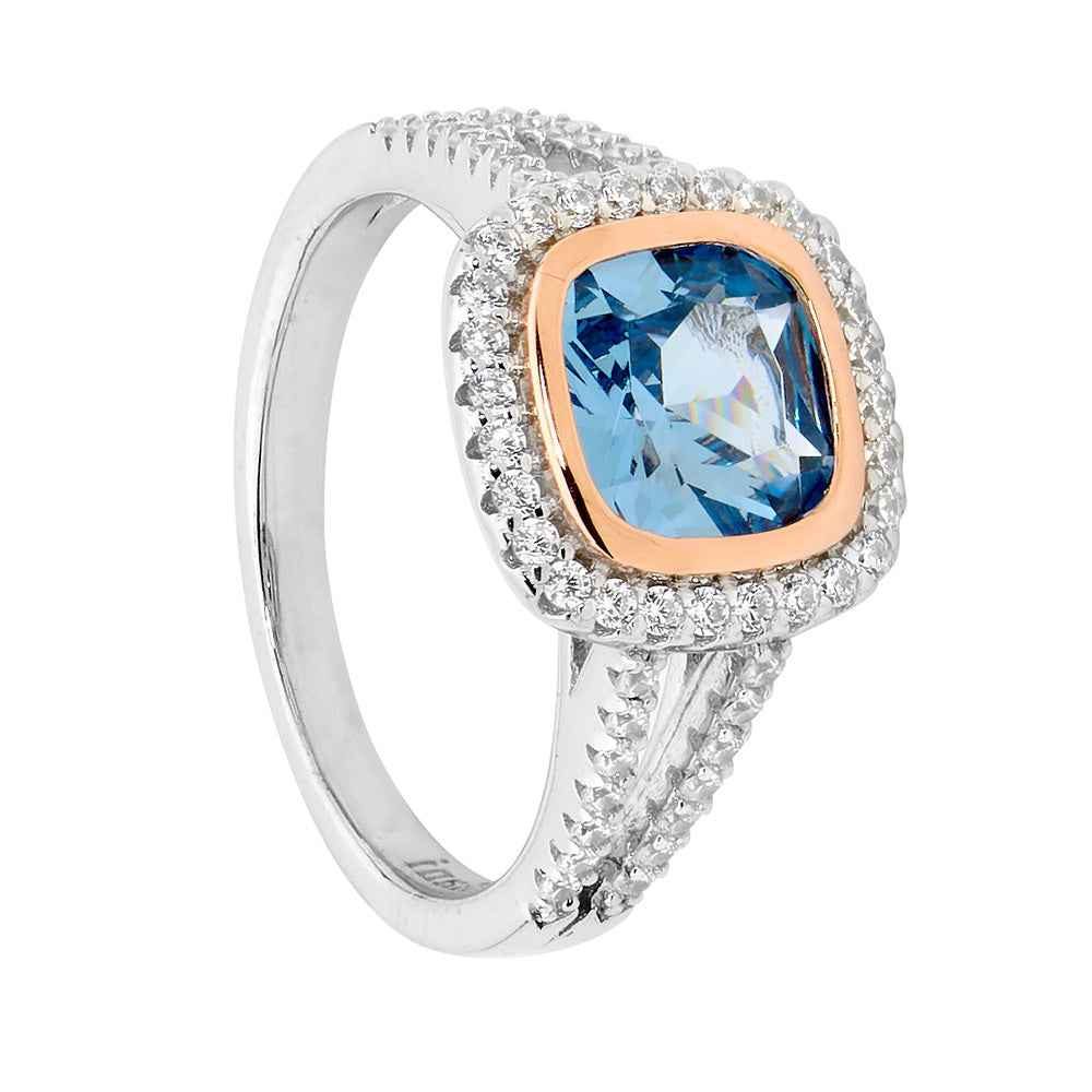 Blue spinel and CZ halo ring in sterling silver and rose gold plating
