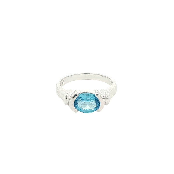 Oval blue topaz semi rubover ring in sterling silver