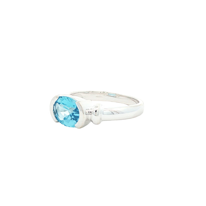 Oval blue topaz semi rubover ring in sterling silver
