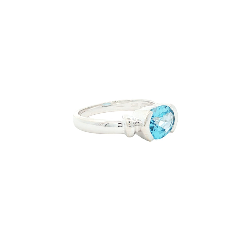 Oval blue topaz semi rubover ring in sterling silver