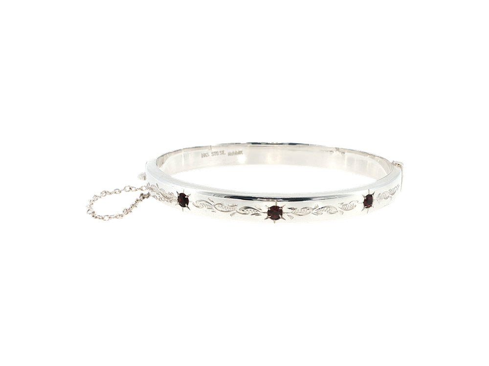 Engraved hinged bangle set with three garnets in sterling silver