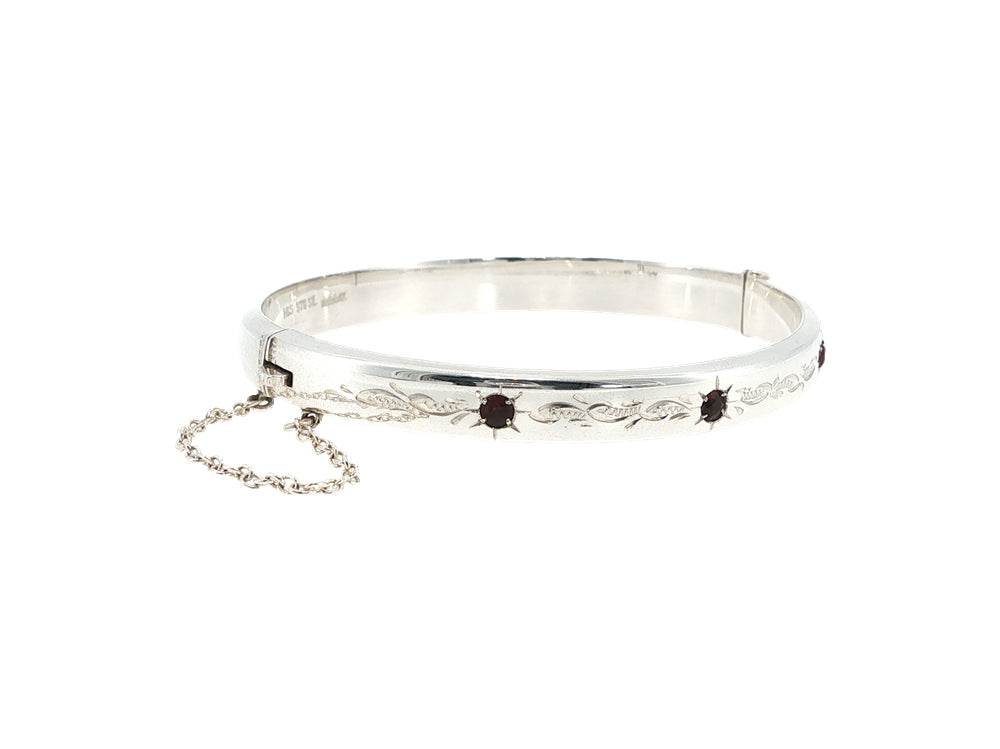 Engraved hinged bangle set with three garnets in sterling silver