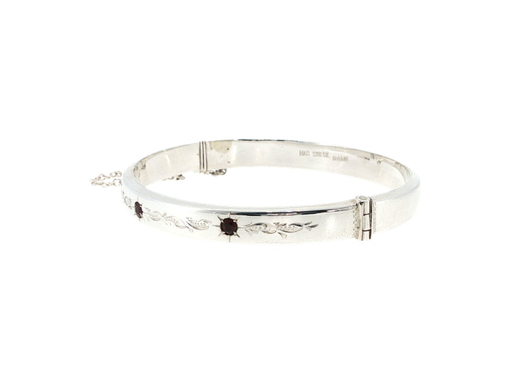 Engraved hinged bangle set with three garnets in sterling silver