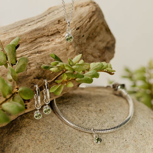 Silver August Birthstone Huggie earrings from Evolve - Peridot