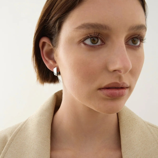 Silver horseshoe huggie earrings from Najo