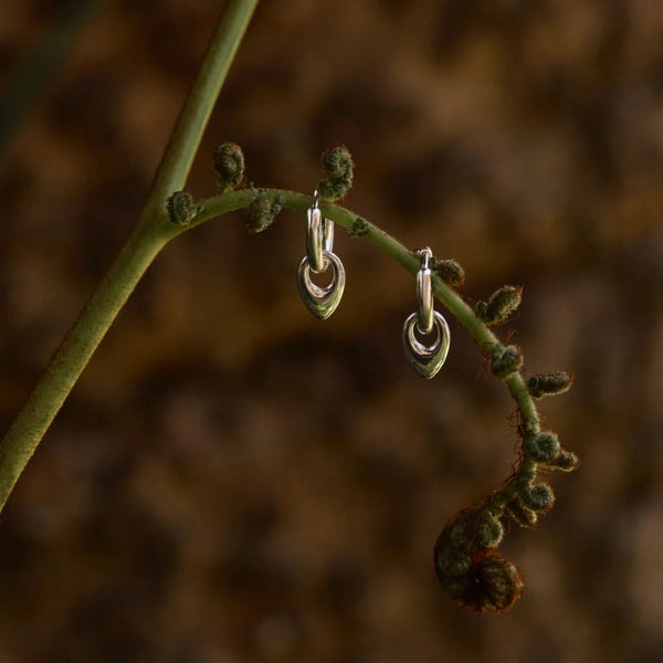 Najo - Petal huggie earring with teardrop charm in sterling silver