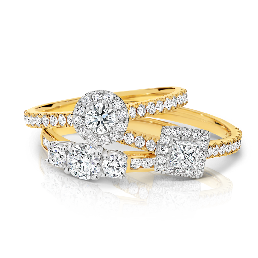 Stack of three yellow gold engagement rings available from showcase jewellers te awamutu